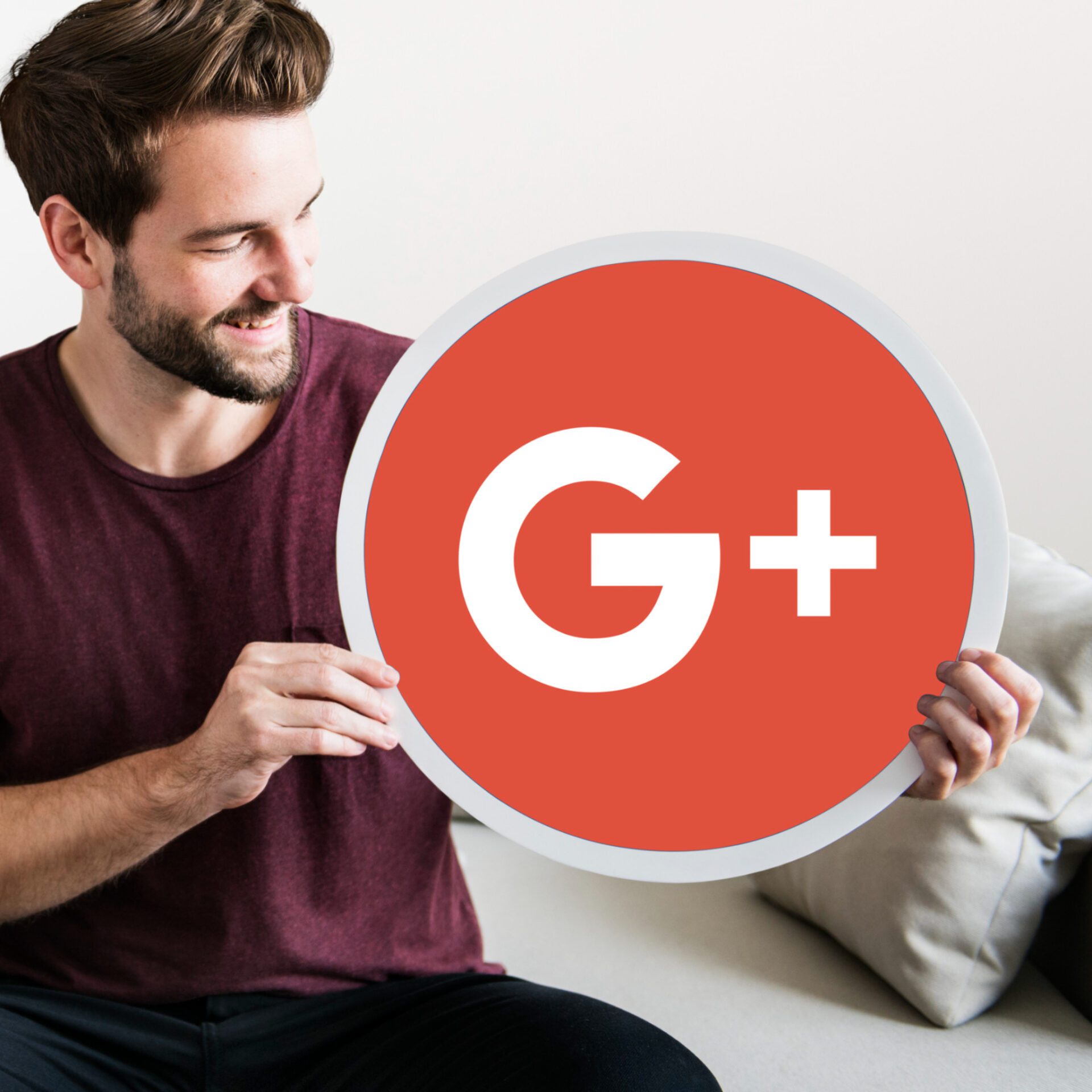 Person holding a Google Plus icon